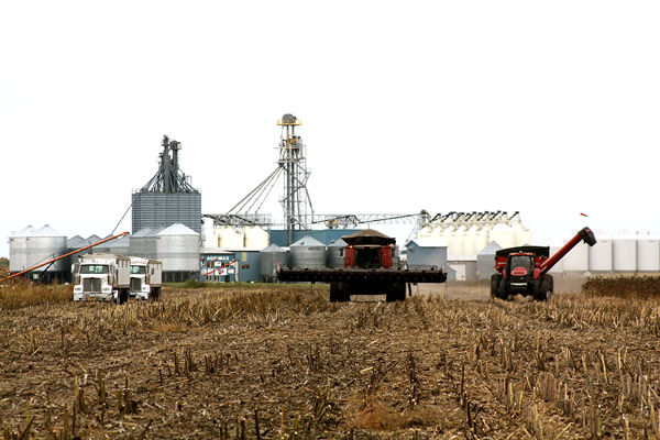 trucks in field with facility